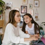 Woman distracted from work by her daughter
