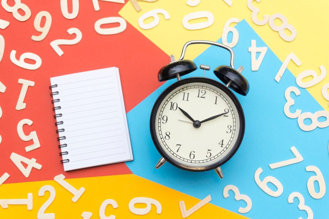alarm-clock-lying-on-multicolored-surface