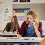 Student taking notes in class