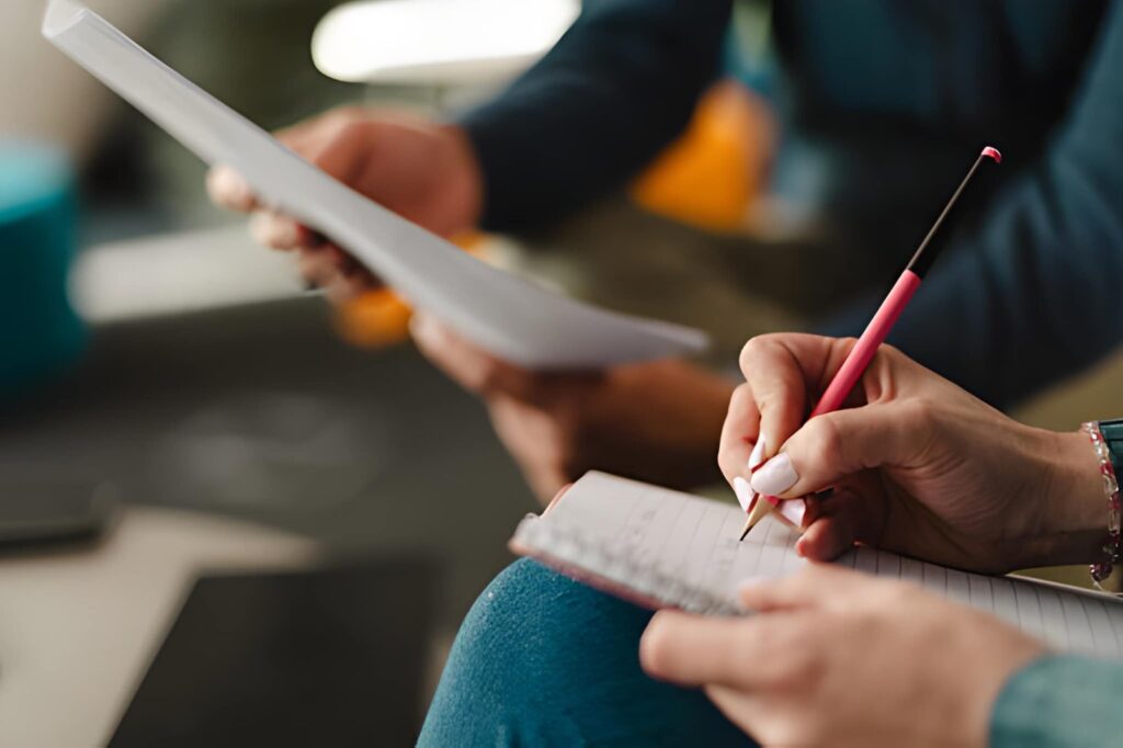 Focused on taking notes during a meeting