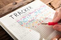 Person marking their tracker book