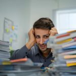 exhausted-male-employee-dealing-with-pressure-and-disappointment-from-work